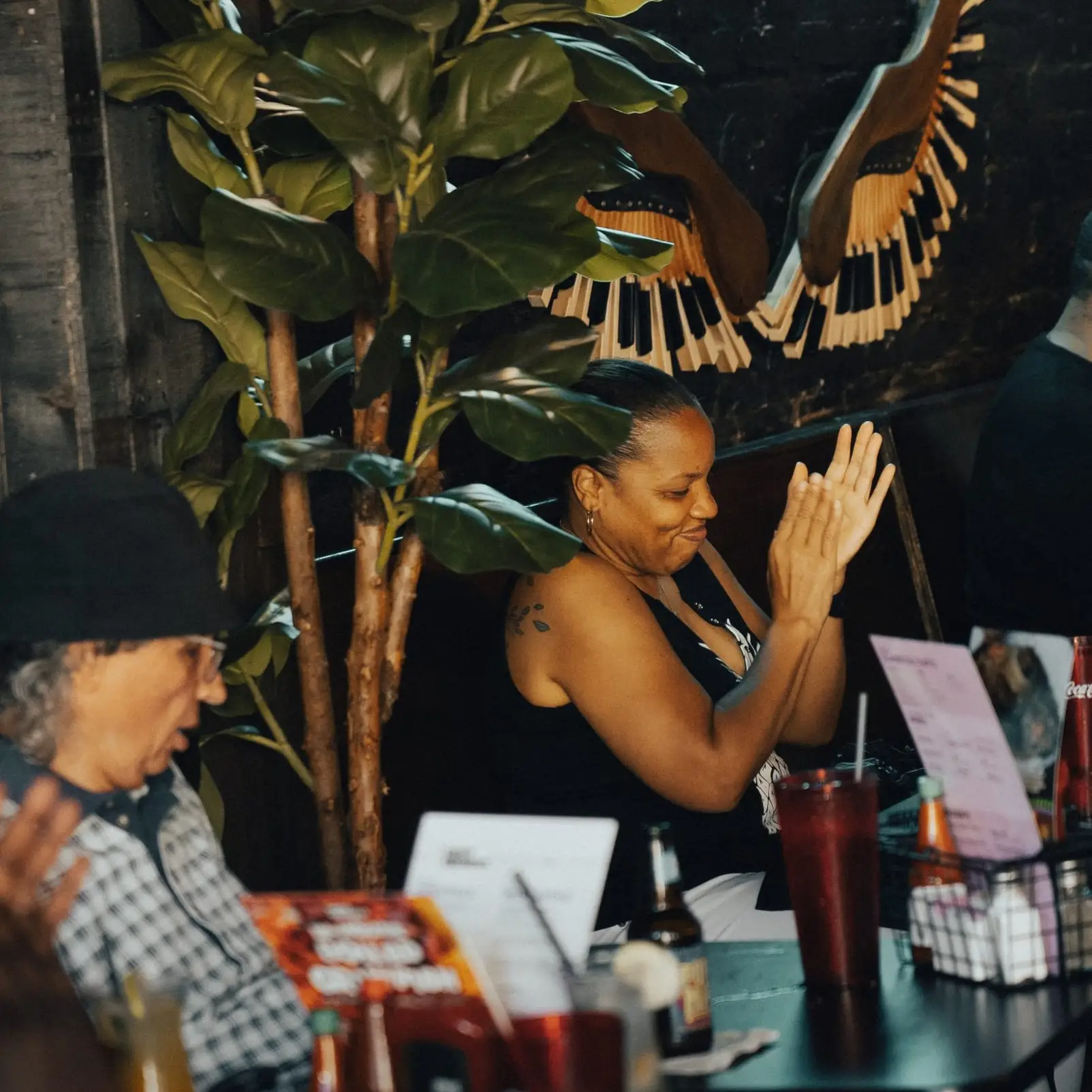A guest clapping along to the band from her table